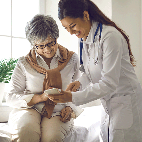 Female doctor consulting with elder female patient
